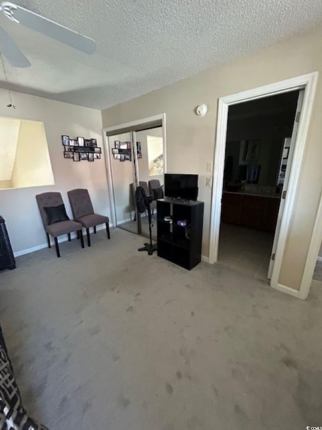 4396 Baldwin Ave Unit C-24, Little River, SC 29566 - living room featuring ceiling fan, baseboards, and a textured ceiling