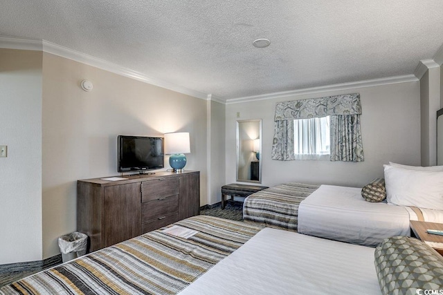 1105 S Ocean Blvd Unit 502, Myrtle Beach, SC 29577 - bedroom featuring ornamental molding, a textured ceiling, and baseboards
