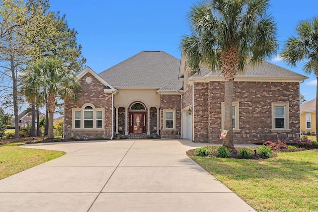 2039 Woodburn Dr, Myrtle Beach, SC 29579 - traditional home featuring driveway, a front lawn, an attached garage, and brick siding