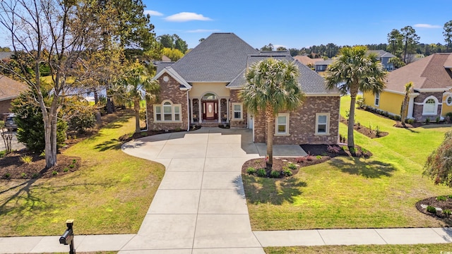 2039 Woodburn Dr, Myrtle Beach, SC 29579 - view of front of home with brick siding, a front yard, and driveway