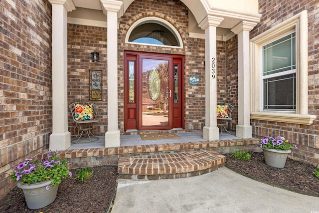 2039 Woodburn Dr, Myrtle Beach, SC 29579 - doorway to property featuring covered porch and brick siding