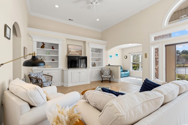 2039 Woodburn Dr, Myrtle Beach, SC 29579 - living room with arched walkways, healthy amount of natural light, light tile patterned floors, a ceiling fan, and ornamental molding