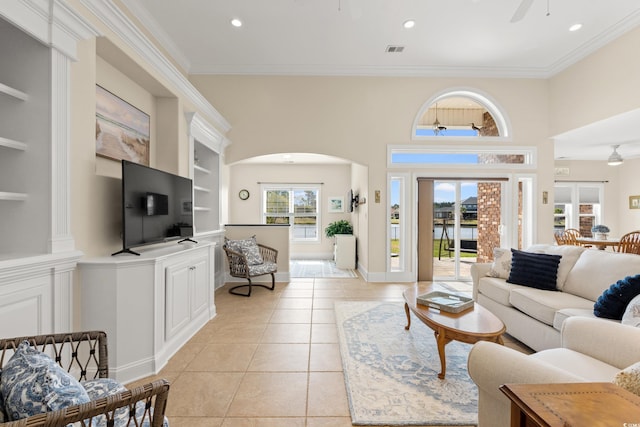 2039 Woodburn Dr, Myrtle Beach, SC 29579 - living room with light tile patterned flooring, arched walkways, built in features, crown molding, and a ceiling fan