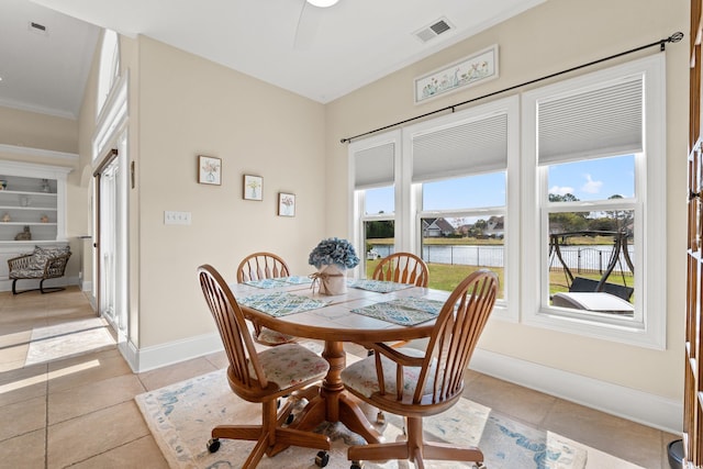 2039 Woodburn Dr, Myrtle Beach, SC 29579 - dining space featuring light tile patterned floors, baseboards, a water view, and ornamental molding