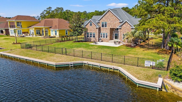 2039 Woodburn Dr, Myrtle Beach, SC 29579 - back of house featuring a water view, a lawn, a patio area, and brick siding