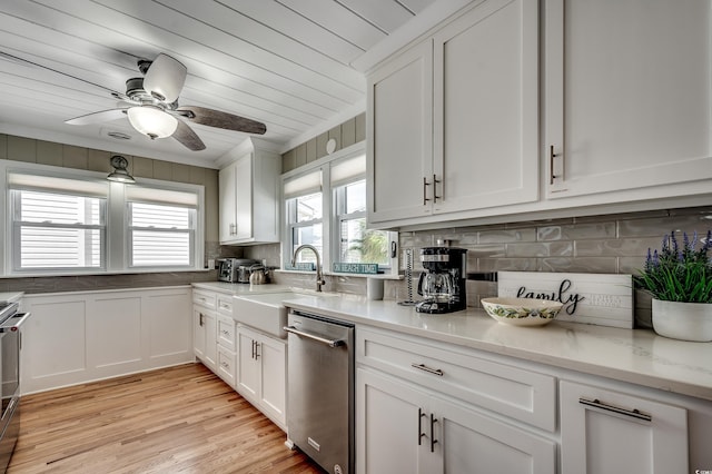 kitchen featuring a sink, ceiling fan, appliances with stainless steel finishes, and white cabinetry