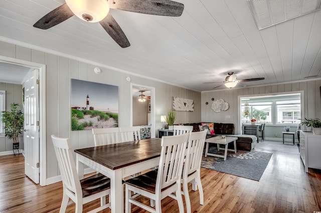 dining room with ornamental molding, visible vents, ceiling fan, and light wood-type flooring