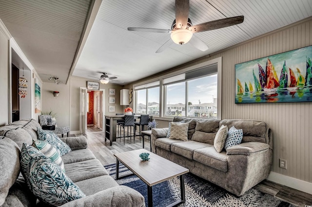 living room with ceiling fan, wood finished floors, and baseboards