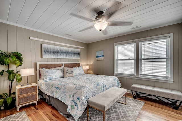 bedroom featuring visible vents, ceiling fan, crown molding, and wood finished floors