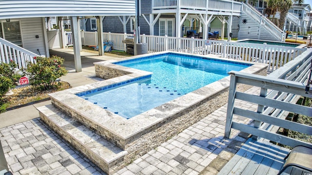 view of swimming pool featuring a patio and a fenced in pool