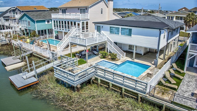 back of property with stairs, a patio, a fenced backyard, and a shingled roof