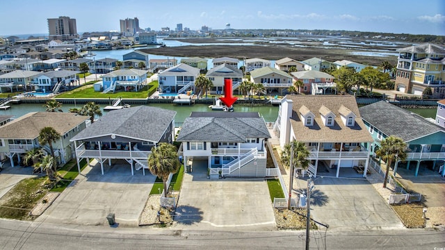 birds eye view of property featuring a residential view and a water view