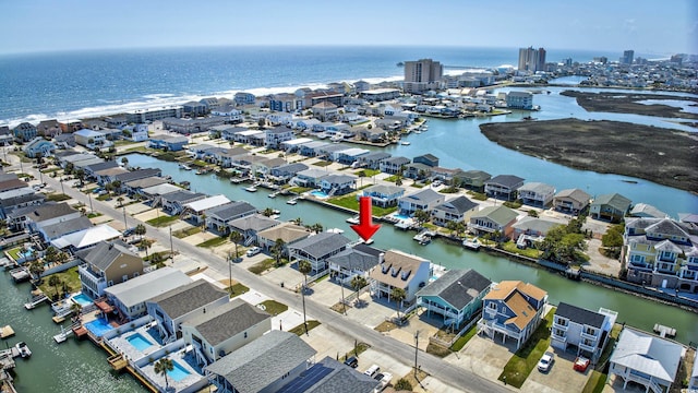 drone / aerial view featuring a residential view and a water view