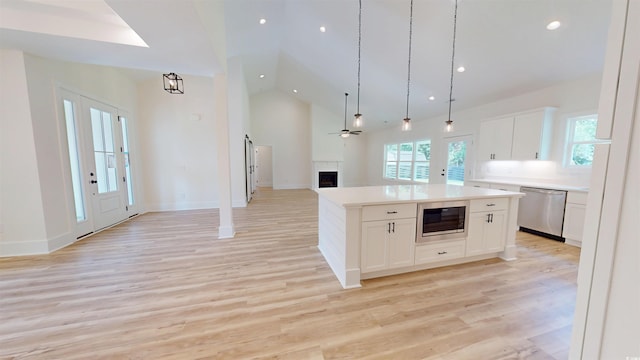 974 Crooked Oak Dr, Pawleys Island, SC 29585 - kitchen with dishwasher, open floor plan, built in microwave, white cabinetry, and light countertops