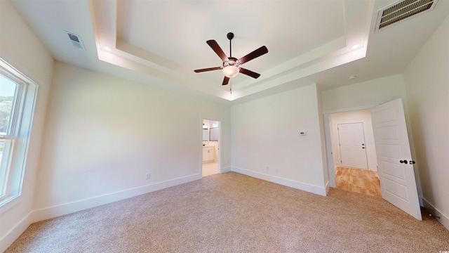 974 Crooked Oak Dr, Pawleys Island, SC 29585 - unfurnished bedroom with a raised ceiling, carpet, connected bathroom, and a ceiling fan