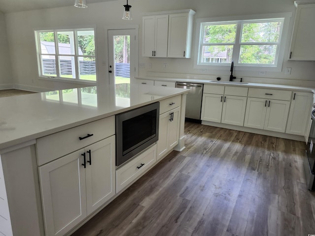 974 Crooked Oak Dr, Pawleys Island, SC 29585 - kitchen featuring stainless steel appliances, plenty of natural light, white cabinetry, and light countertops