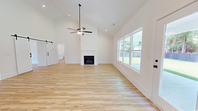 974 Crooked Oak Dr, Pawleys Island, SC 29585 - unfurnished living room with ceiling fan, a fireplace, a barn door, light wood-type flooring, and recessed lighting