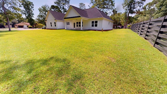 974 Crooked Oak Dr, Pawleys Island, SC 29585 - rear view of property featuring board and batten siding and a yard