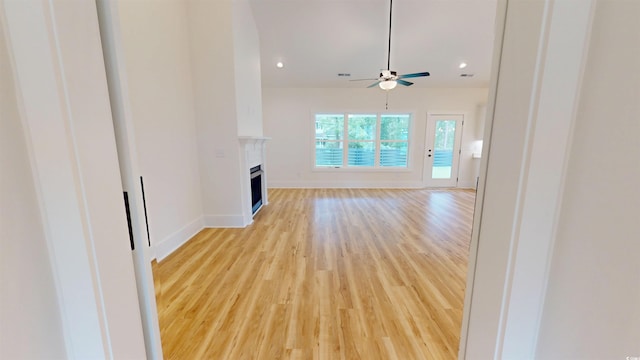 974 Crooked Oak Dr, Pawleys Island, SC 29585 - unfurnished living room featuring light wood finished floors, ceiling fan, a fireplace, and recessed lighting
