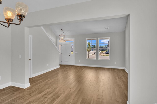1105 NW Forest Bend Dr, Calabash, NC 28467 - entrance foyer featuring baseboards, an inviting chandelier, and wood finished floors
