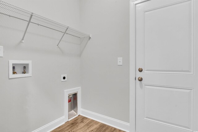 laundry room with electric dryer hookup, baseboards, washer hookup, laundry area, and wood finished floors