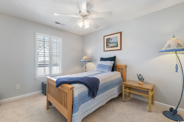 bedroom with light carpet, baseboards, a ceiling fan, and visible vents