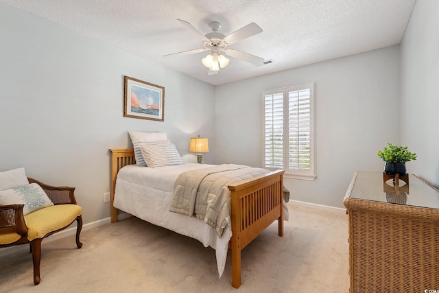 bedroom with light carpet, ceiling fan, baseboards, and visible vents