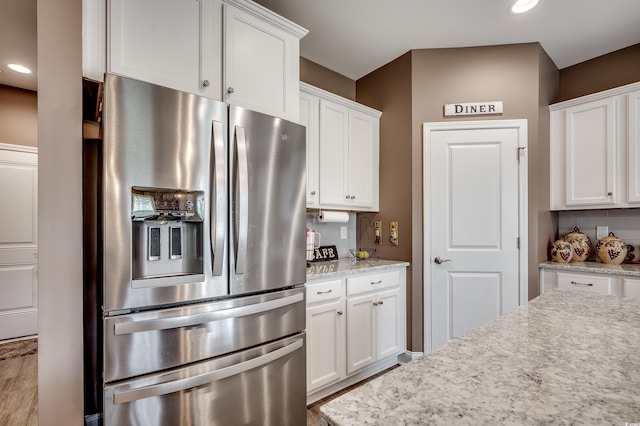 3613 Pitchers Pl, Little River, SC 29566 - kitchen with stainless steel fridge, white cabinetry, recessed lighting, wood finished floors, and light stone counters