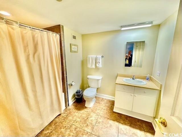bathroom featuring tile patterned floors, vanity, baseboards, toilet, and visible vents