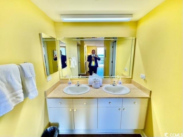 full bath featuring a sink and double vanity