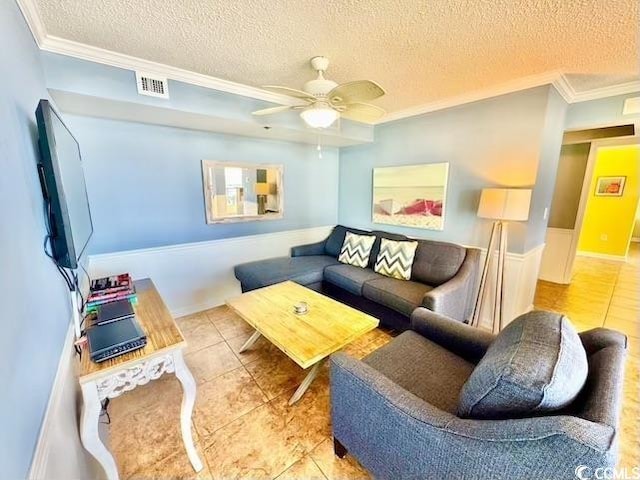 living room with a ceiling fan, tile patterned flooring, and a textured ceiling
