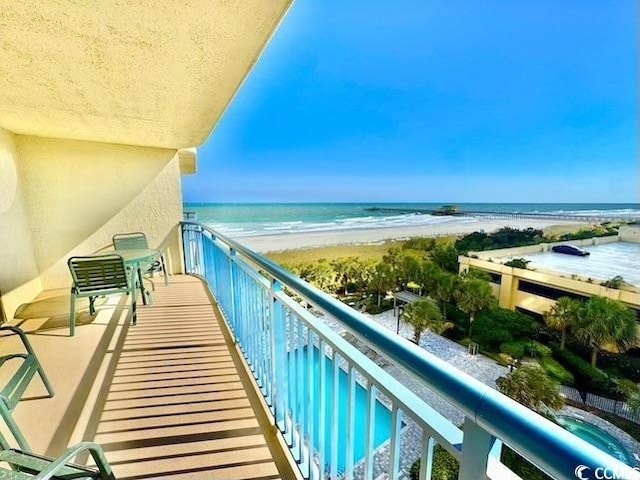 balcony with a view of the beach and a water view