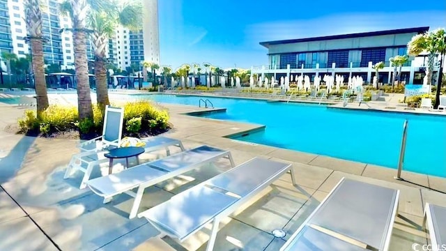 community pool with a patio area