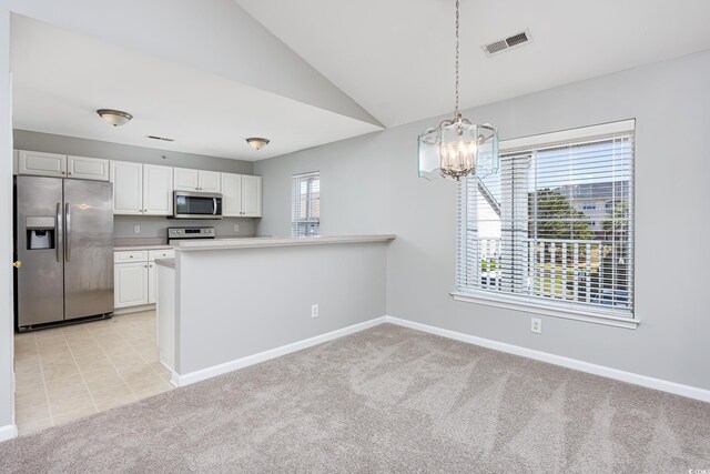 117 Butkus Dr Unit 5, Myrtle Beach, SC 29588 - kitchen featuring appliances with stainless steel finishes, light colored carpet, baseboards, a chandelier, and white cabinetry