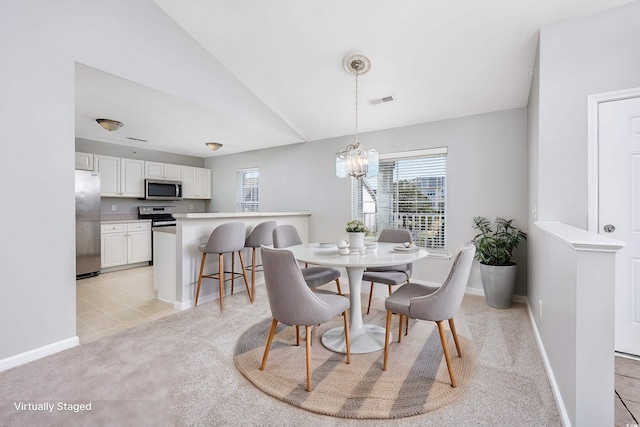 117 Butkus Dr Unit 5, Myrtle Beach, SC 29588 - dining room with healthy amount of natural light, a chandelier, baseboards, light carpet, and vaulted ceiling