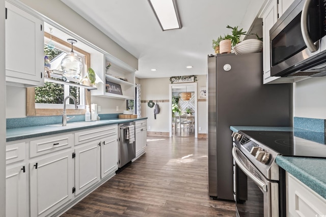kitchen featuring a sink, white cabinets, appliances with stainless steel finishes, and dark wood-style floors