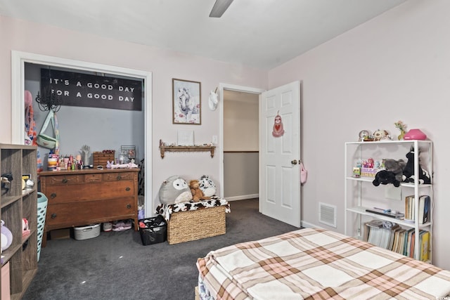 bedroom with dark carpet, visible vents, and a ceiling fan