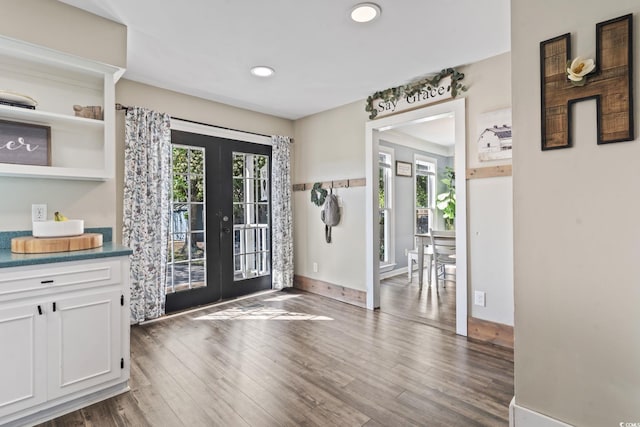 entryway with dark wood-type flooring, french doors, baseboards, and recessed lighting