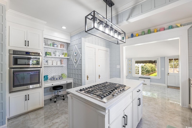 kitchen featuring marble finish floor, stainless steel appliances, light countertops, crown molding, and white cabinetry