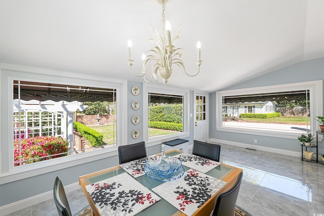 dining area featuring plenty of natural light, lofted ceiling, visible vents, and an inviting chandelier