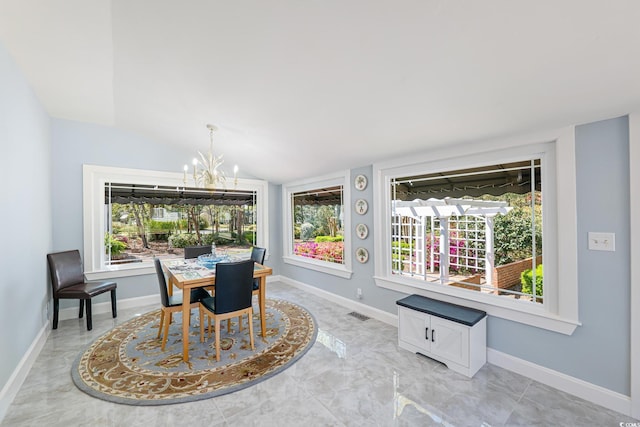 dining area with vaulted ceiling, a notable chandelier, and baseboards