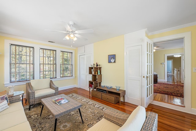 living room featuring crown molding, wood finished floors, and a ceiling fan