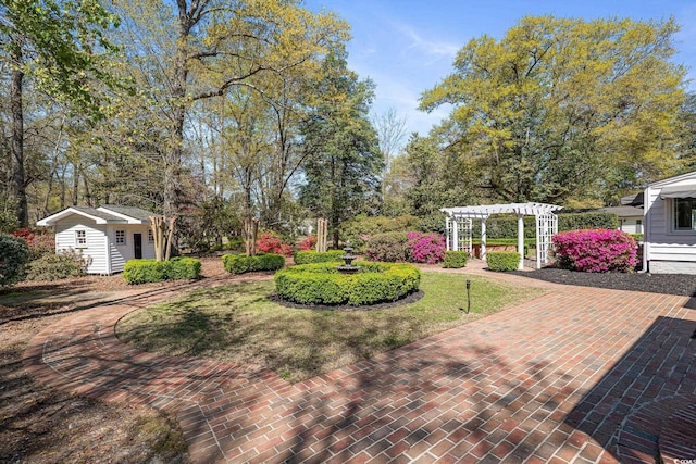 view of yard featuring a pergola and an outdoor structure
