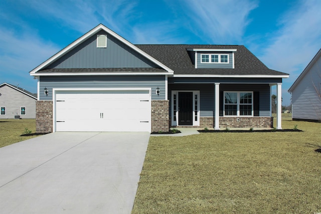 craftsman-style house with brick siding, a front yard, an attached garage, and concrete driveway
