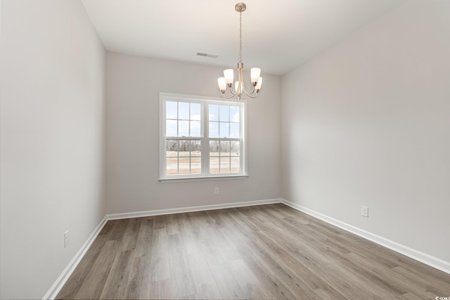 364 Hayloft Cir, Conway, SC 29526 - spare room featuring wood finished floors and a chandelier