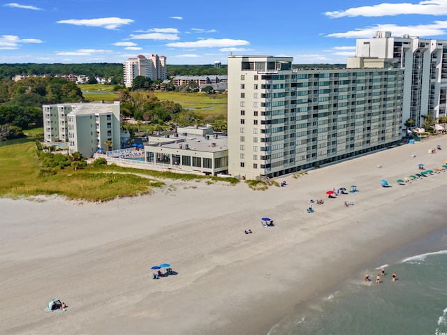 birds eye view of property featuring a beach view and a water view