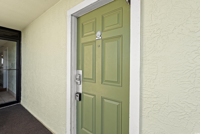 property entrance with stucco siding