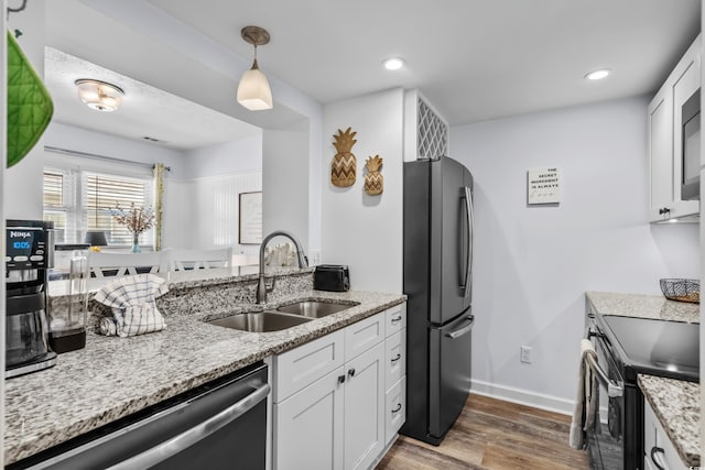 5508 Porcher Dr Unit 3, Myrtle Beach, SC 29577 - kitchen with a sink, freestanding refrigerator, stainless steel dishwasher, electric range, and wood finished floors