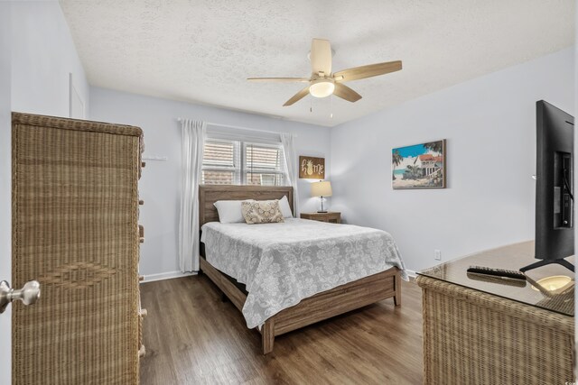 5508 Porcher Dr Unit 3, Myrtle Beach, SC 29577 - bedroom with wood finished floors, a ceiling fan, baseboards, and a textured ceiling
