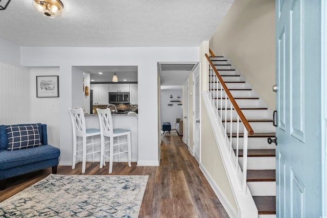 5508 Porcher Dr Unit 3, Myrtle Beach, SC 29577 - entrance foyer with stairs, dark wood-style flooring, a textured ceiling, and baseboards